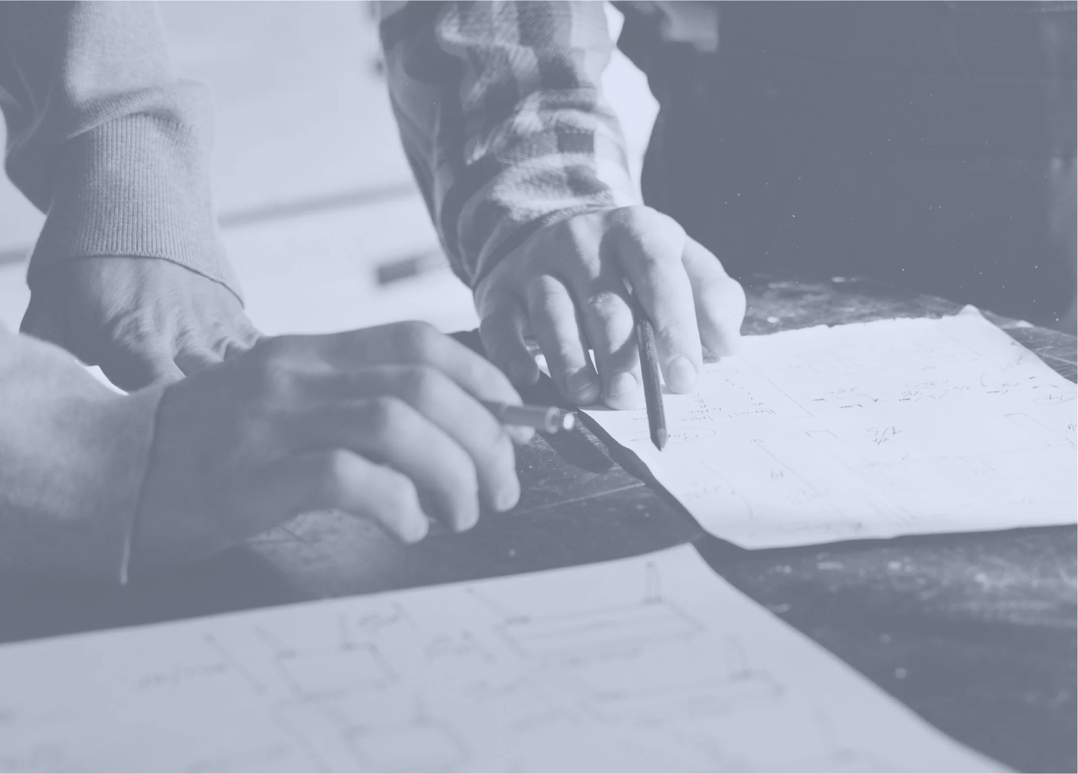 Close-up of someone writing on a notepad with a pen, with a hand holding the notepad steady.