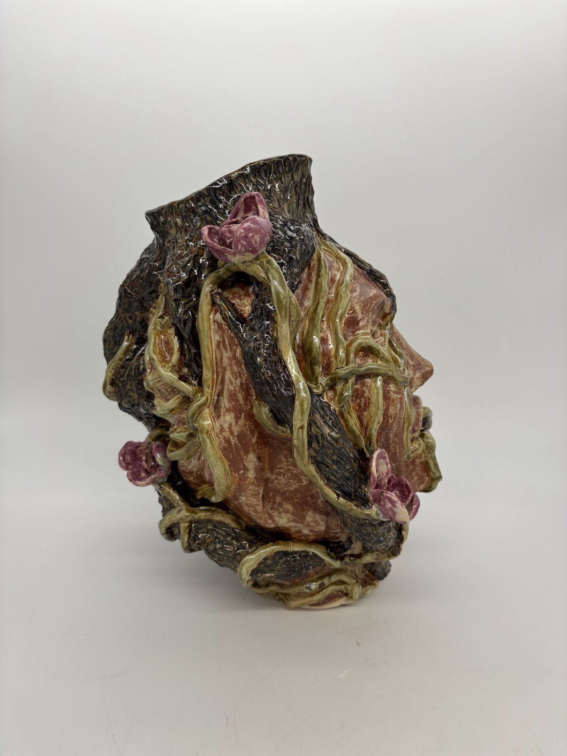Ensnared [side view]. B clay and Overglaze. 15.5” x 12” x 13”. 2025.