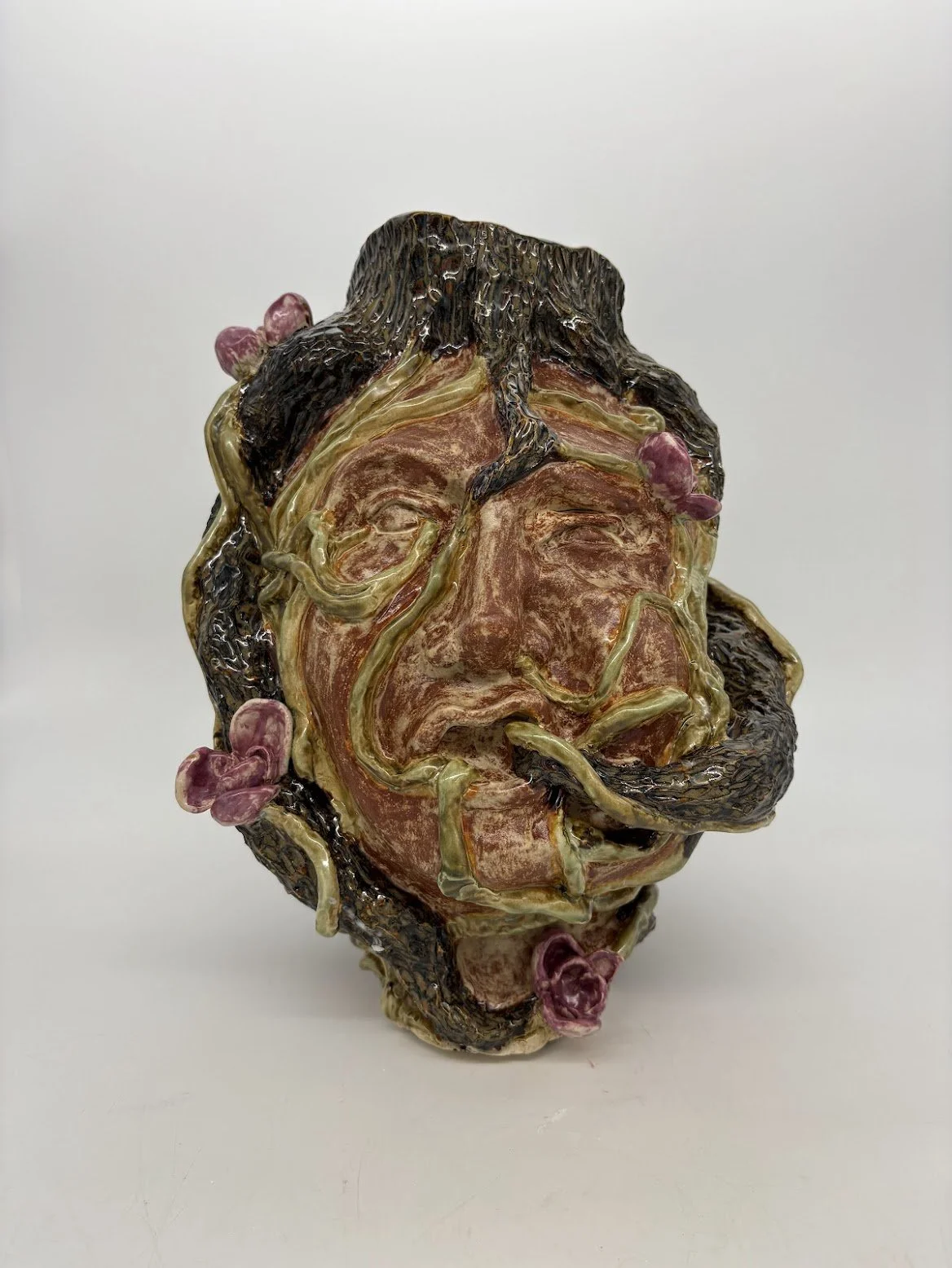 Ensnared [front view]. B clay and Overglaze. 15.5” x 12” x 13”. 2025.