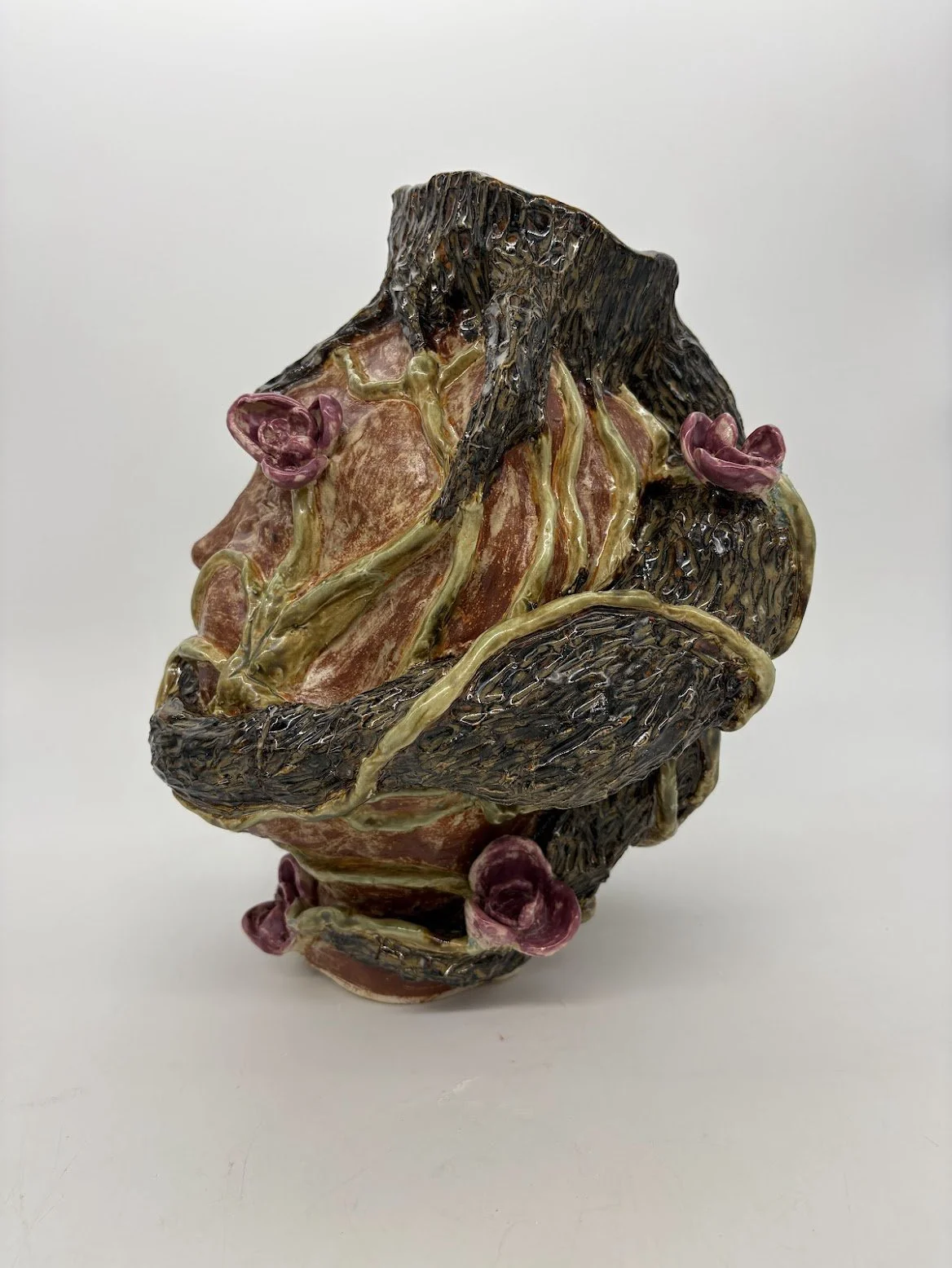 Ensnared [side view]. B clay and Overglaze. 15.5” x 12” x 13”. 2025.