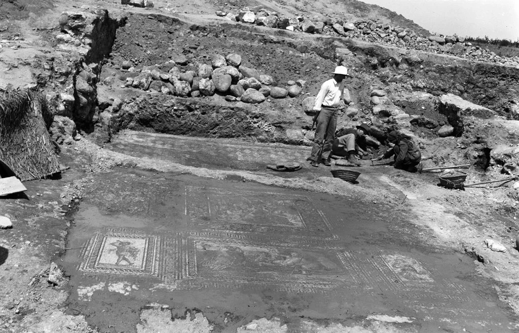 Archaeologists working on an excavation site revealing ancient mosaics.