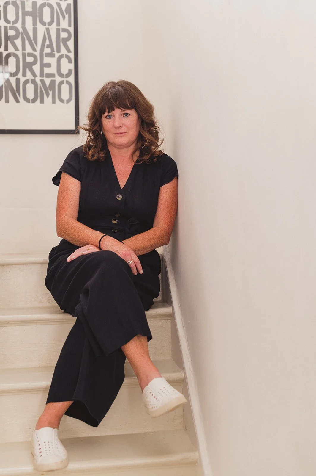An Interior Designer sitting on stairs
