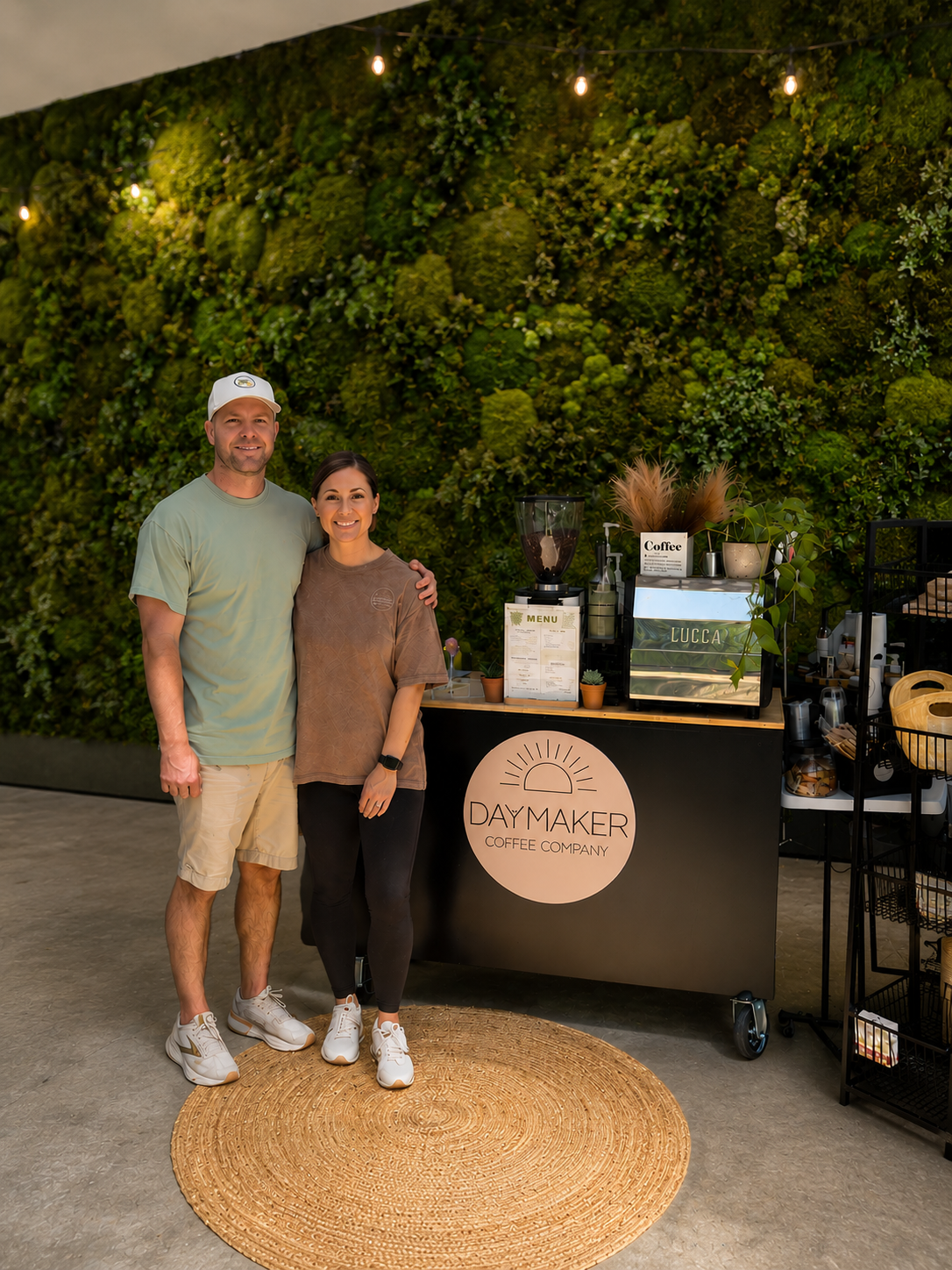 Custom coffee cart activation with moss wall backdrop for corporate event catering