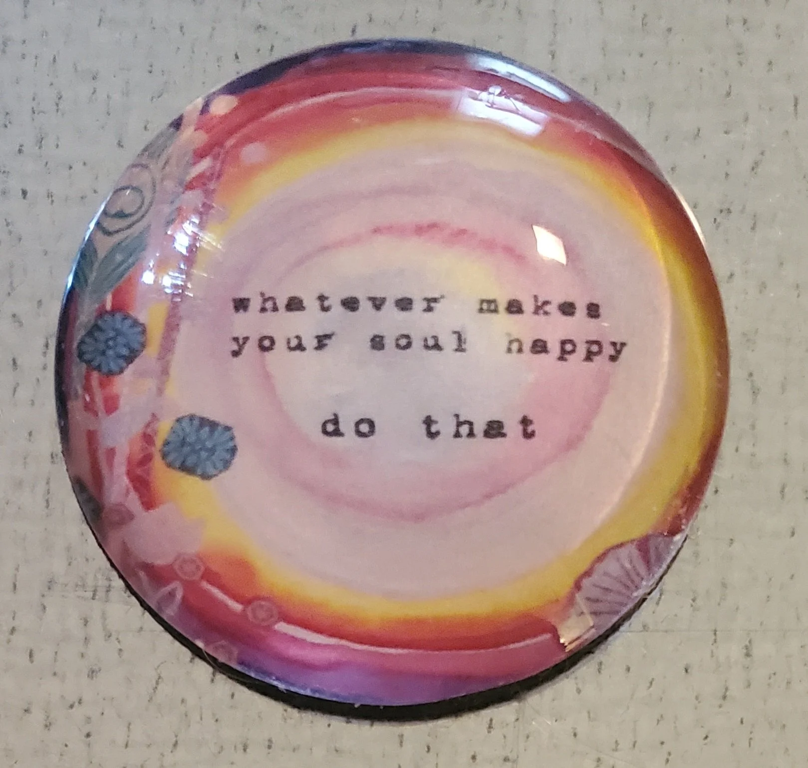 Handmade 2-inch round glass magnet featuring the quote "Whatever makes your soul happy, do that" on a soft watercolor background in warm pink, coral, and golden tones.