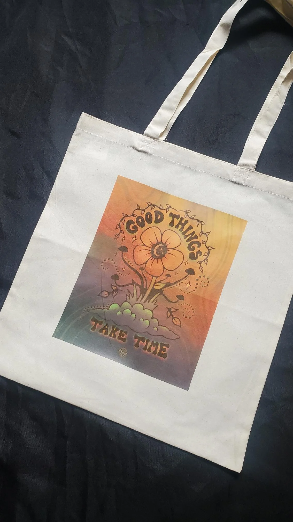 Natural cotton canvas tote bag featuring a colorful floral design with the inspirational phrase "Good Things Take Time."