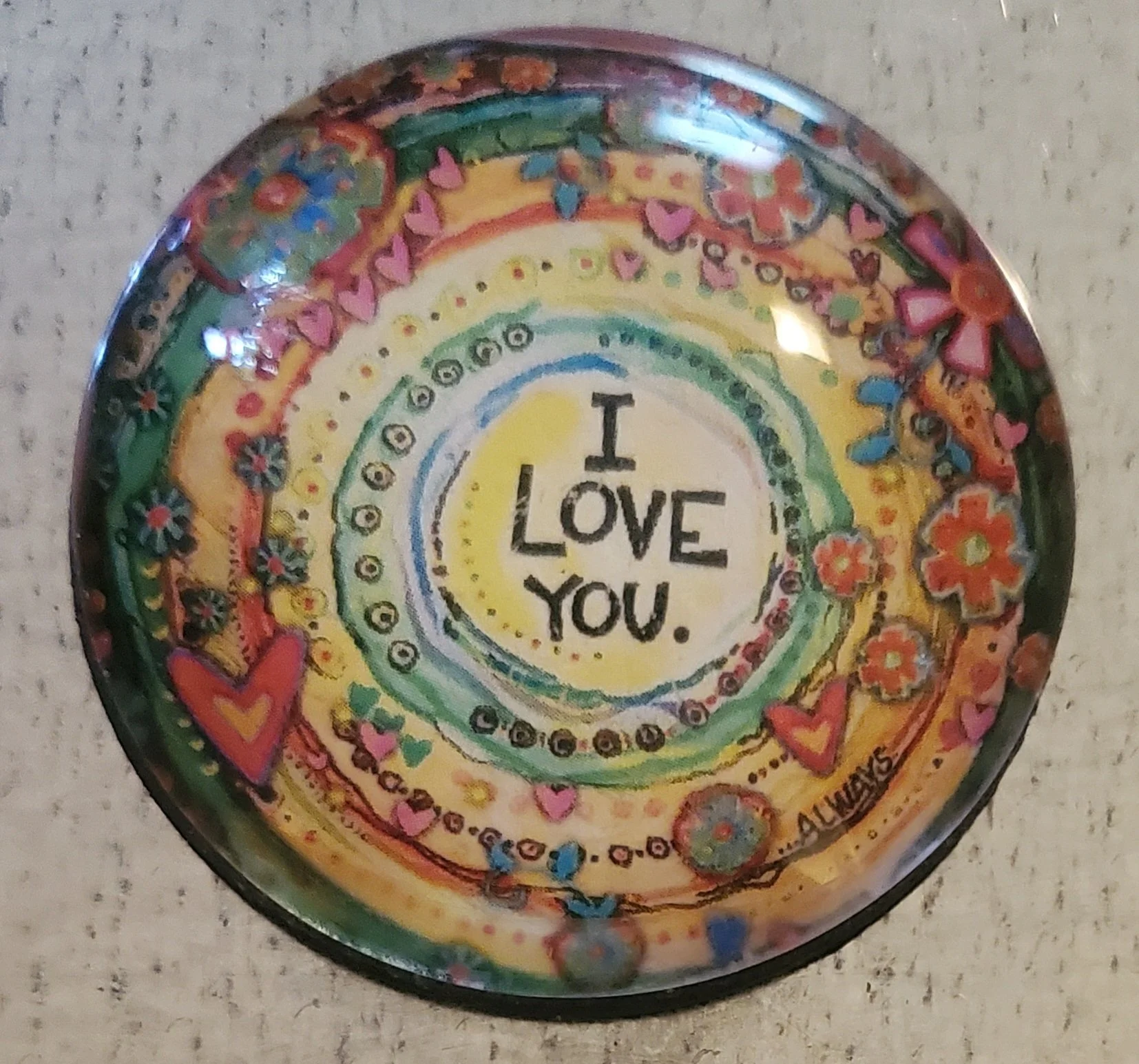 Handmade 2-inch round glass magnet featuring the words "I Love You" surrounded by colorful hearts, flowers, and whimsical boho mandala artwork beneath a crystal-clear glass dome.