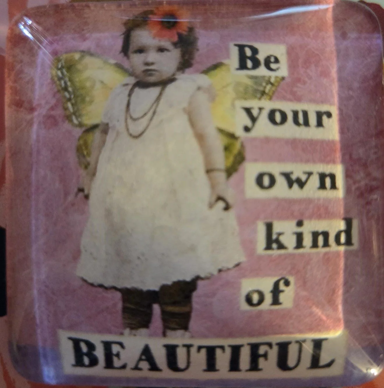 Handmade 2-inch crystal glass magnet featuring a vintage fairy with butterfly wings and the inspirational quote "Be Your Own Kind of Beautiful" on a pink background.