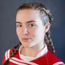 Young girl with braided hair wearing a red and white sports jersey