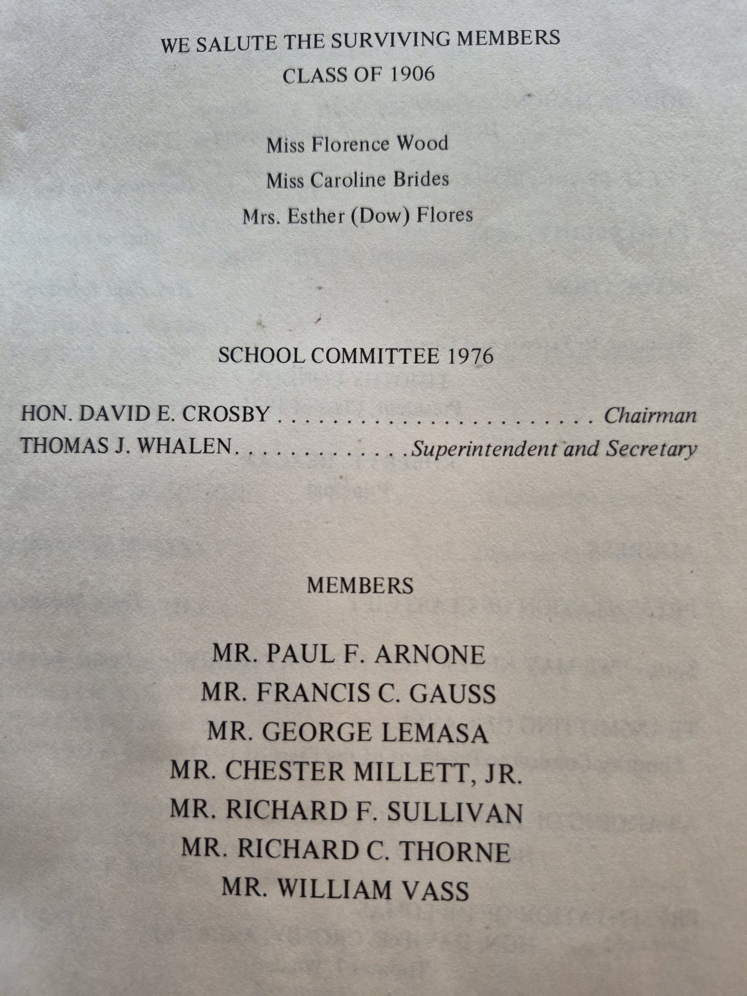 A list on a sheet of paper honoring the surviving members of the class of 1906, including names and titles, with a heading that reads, 'WE SALUTE THE SURVIVING MEMBERS, CLASS OF 1906, SCHOOL COMMITTEE 1976.'