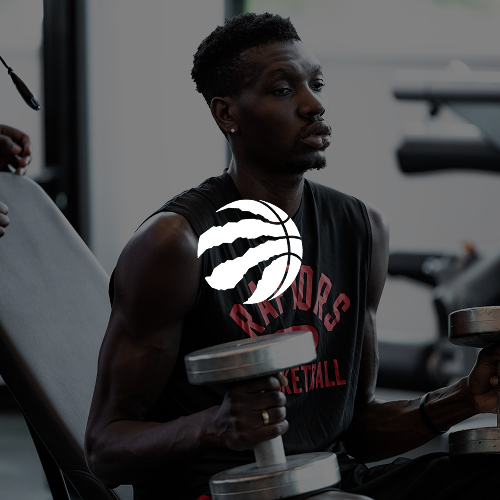 A woman working out with dumbbells in a gym.