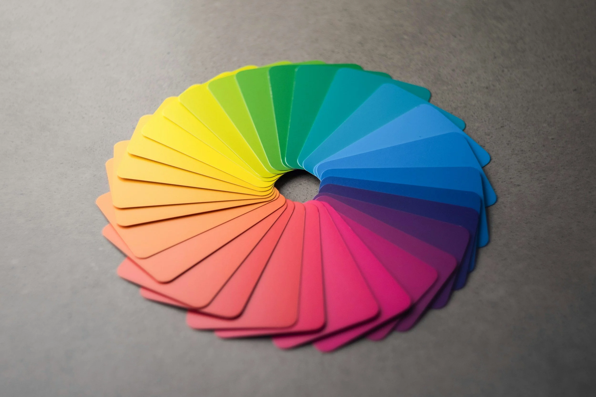 A set of color swatches arranged in a semi-circle, displaying a gradient from yellow to pink.