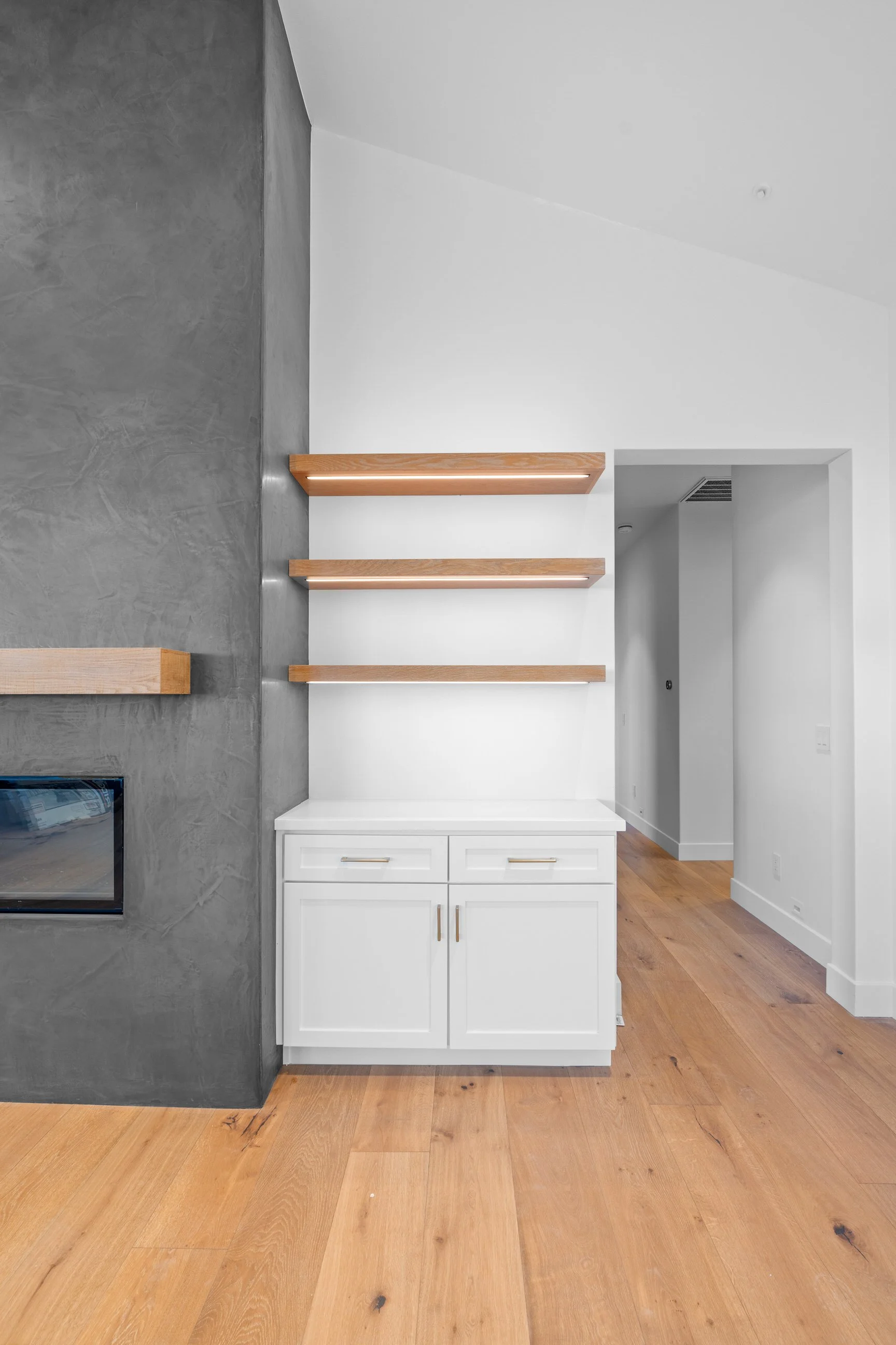 custom open shelving next to modern fireplace