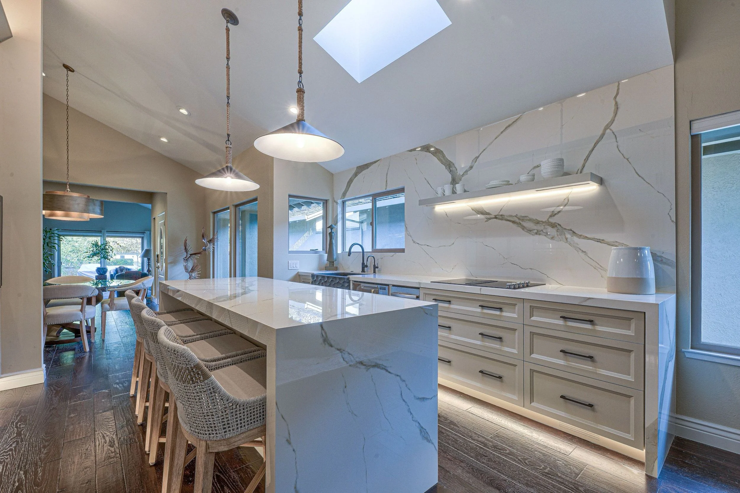 modern floating edge island with natural light and statement pendants
