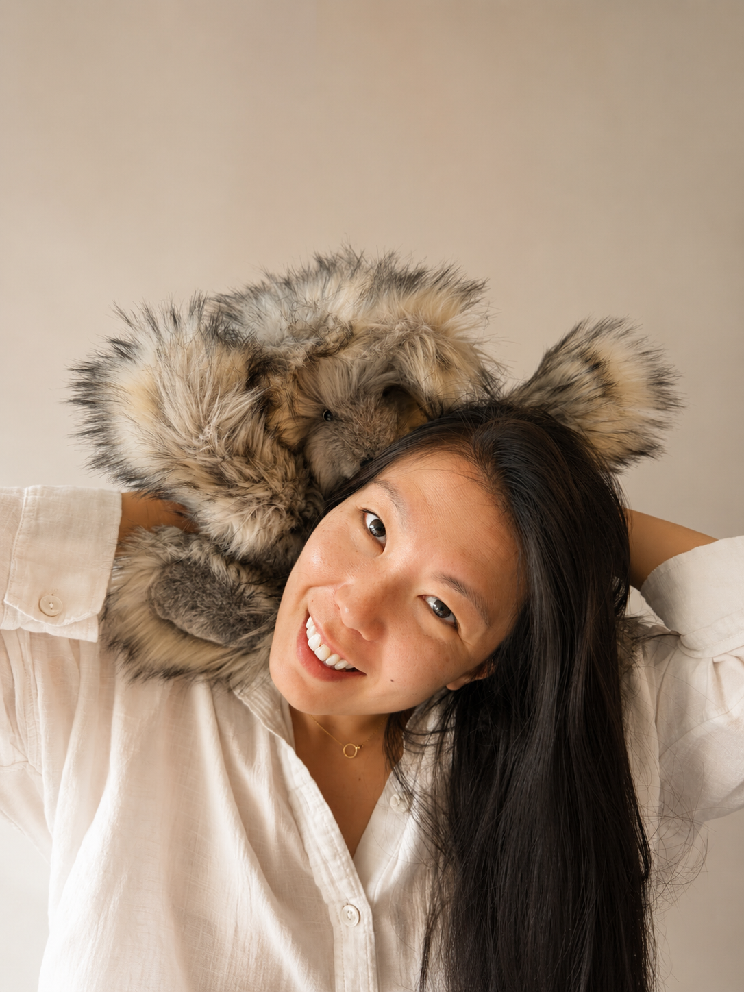 Catherine Ngo, plush artist and founder of The Cuddle Revival. Playfully posed with one of her original bears, named Bear.