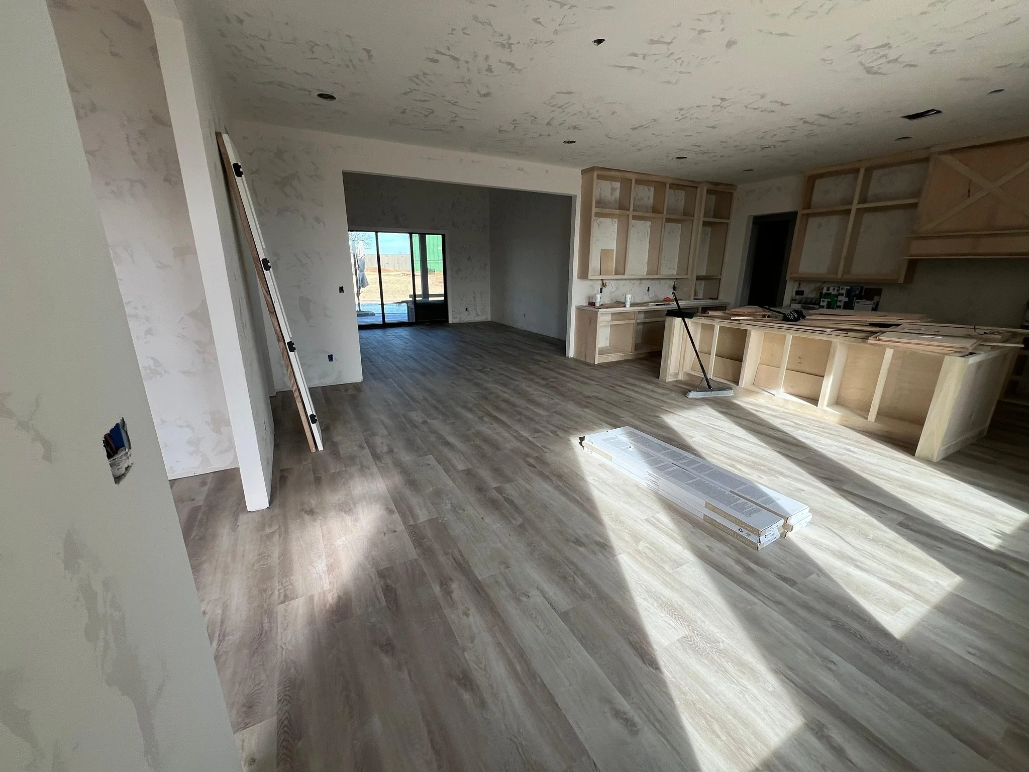 Wide plank wood flooring in a neutral living room