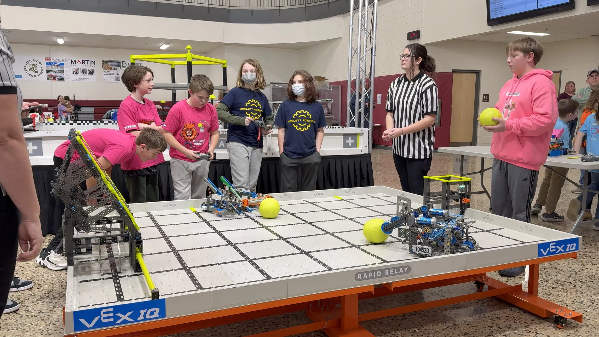 Photograph of a VEX IQ Robotics Competition match from the 2024-2025 season (Rapid Relay) about to begin.