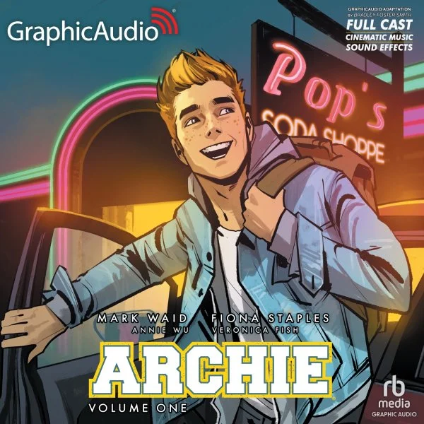 Animated cover art for Archie Volume One by GraphicAudio, depicting a smiling young man with blond hair and freckles, wearing a light blue jacket, holding a backpack strap, standing next to a car, with neon signs and a cinema marquee in the background.
