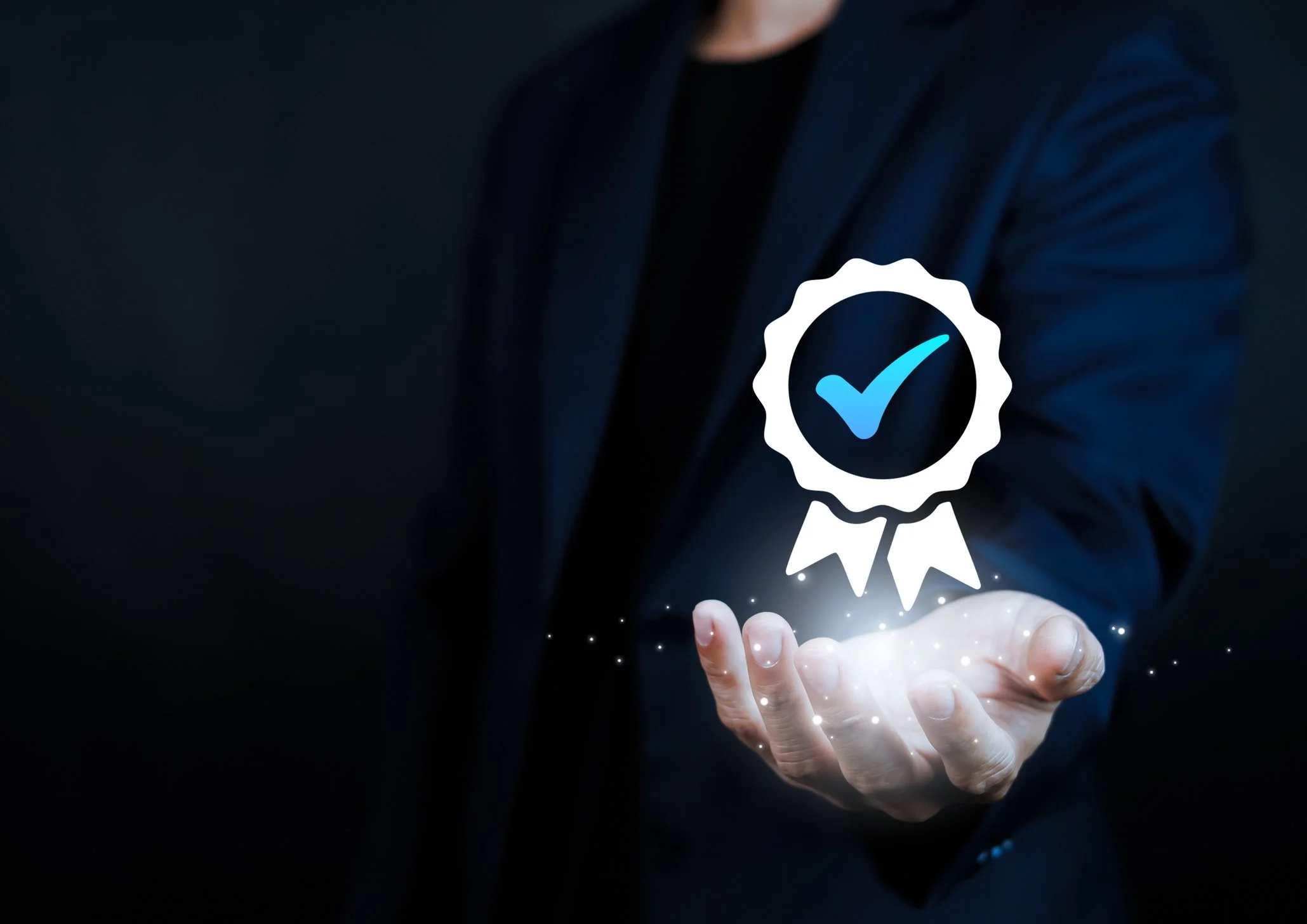 A hand with a floating award symbol in light