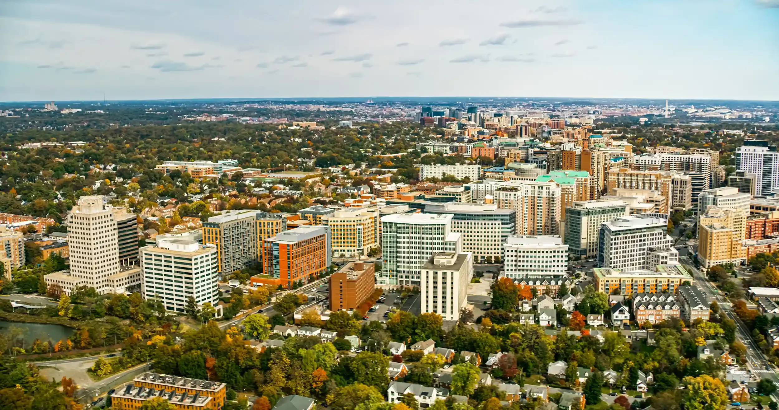 Aerial view of Arlington, Virginia with a mixture of high-rise buildings, residential houses, and greenery