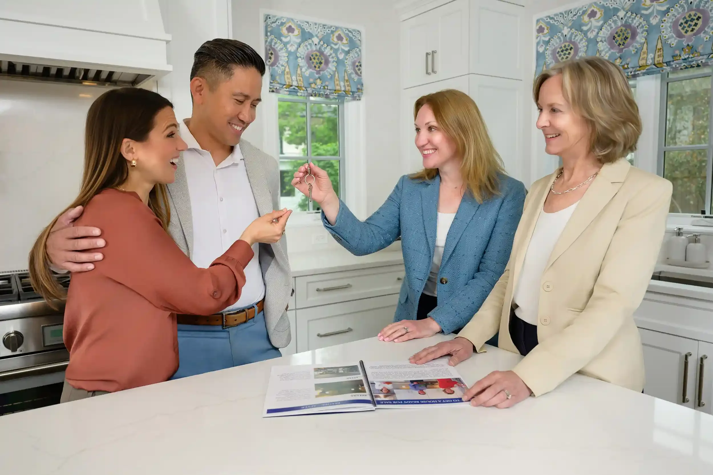 Allison Rivera hands over a set of keys to the clients