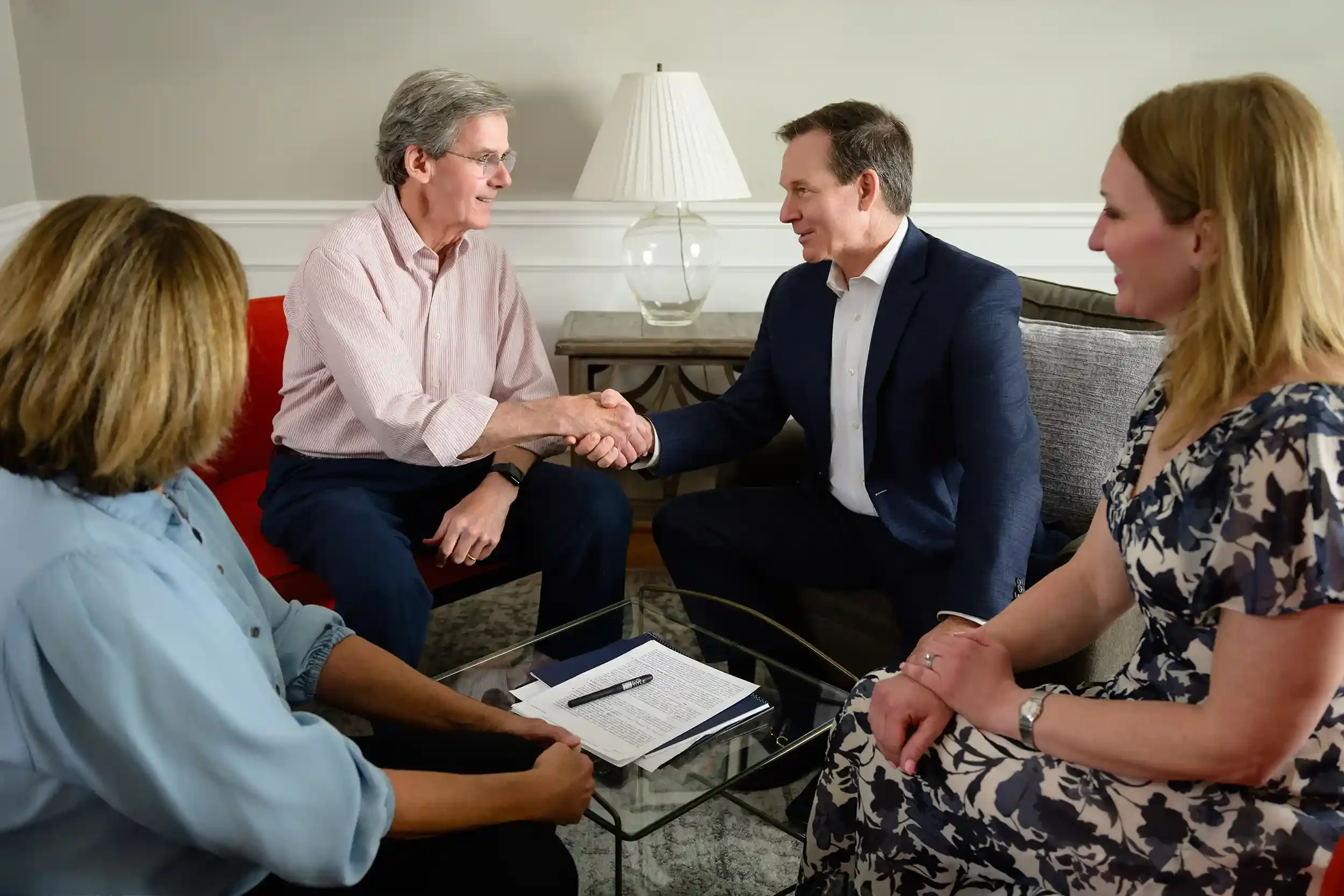 Jeff Beall shaking a clients hand in a meeting in a living room