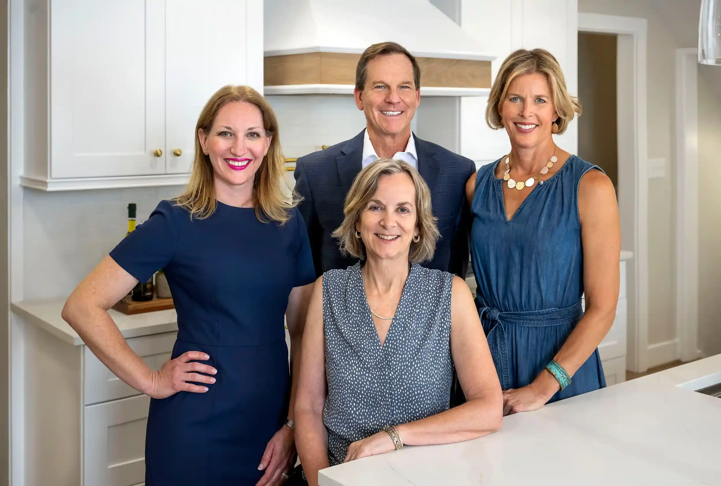 the Beall & Rehill team in a modern white kitchen