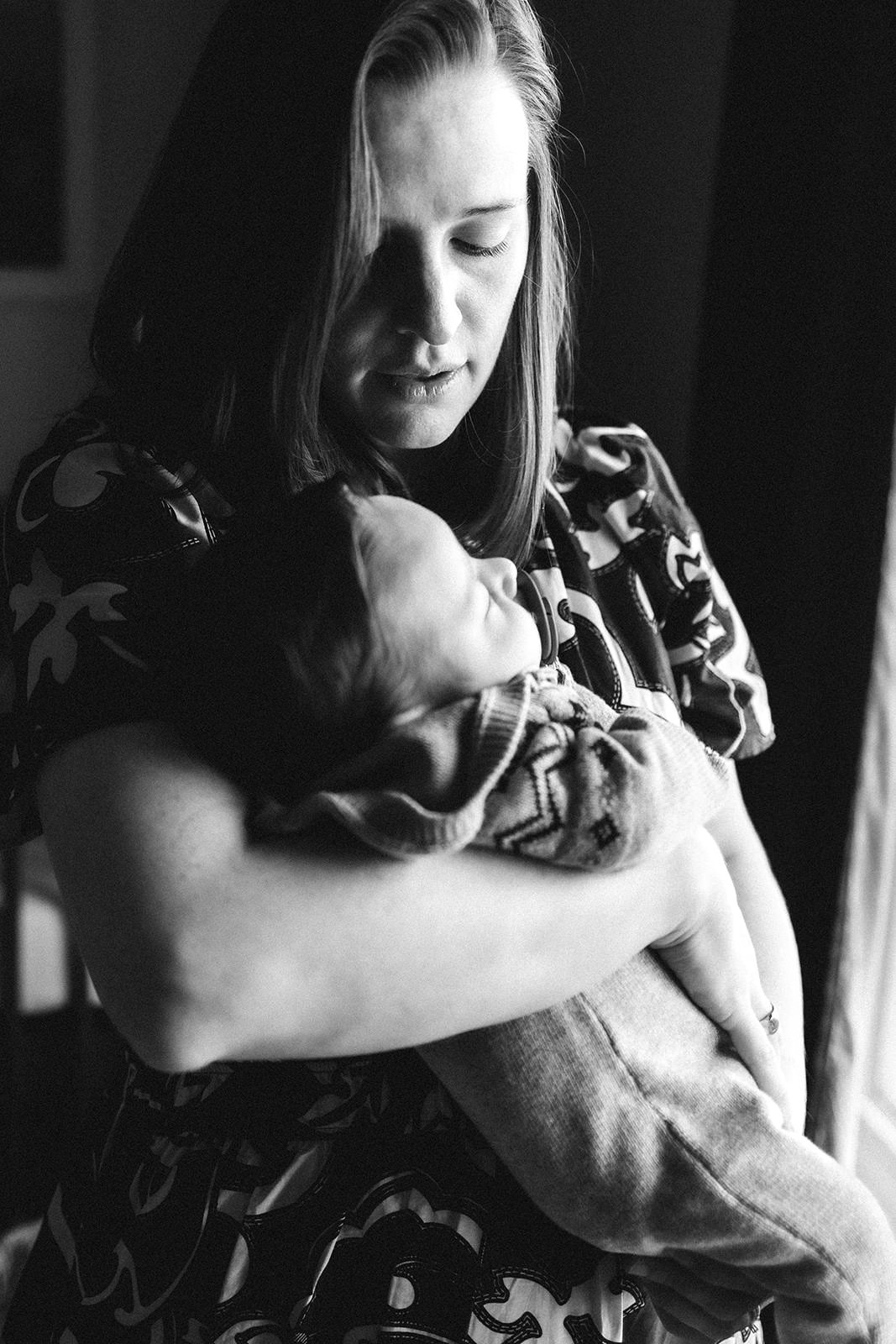 A woman holding and breastfeeding a baby.
