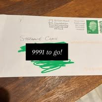 A white envelope with a green stamp and a handwritten address, partially obscured by a black label that says '9991 to go!'