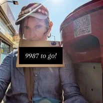 Workshop participant using a postbox to send her letter to a friend