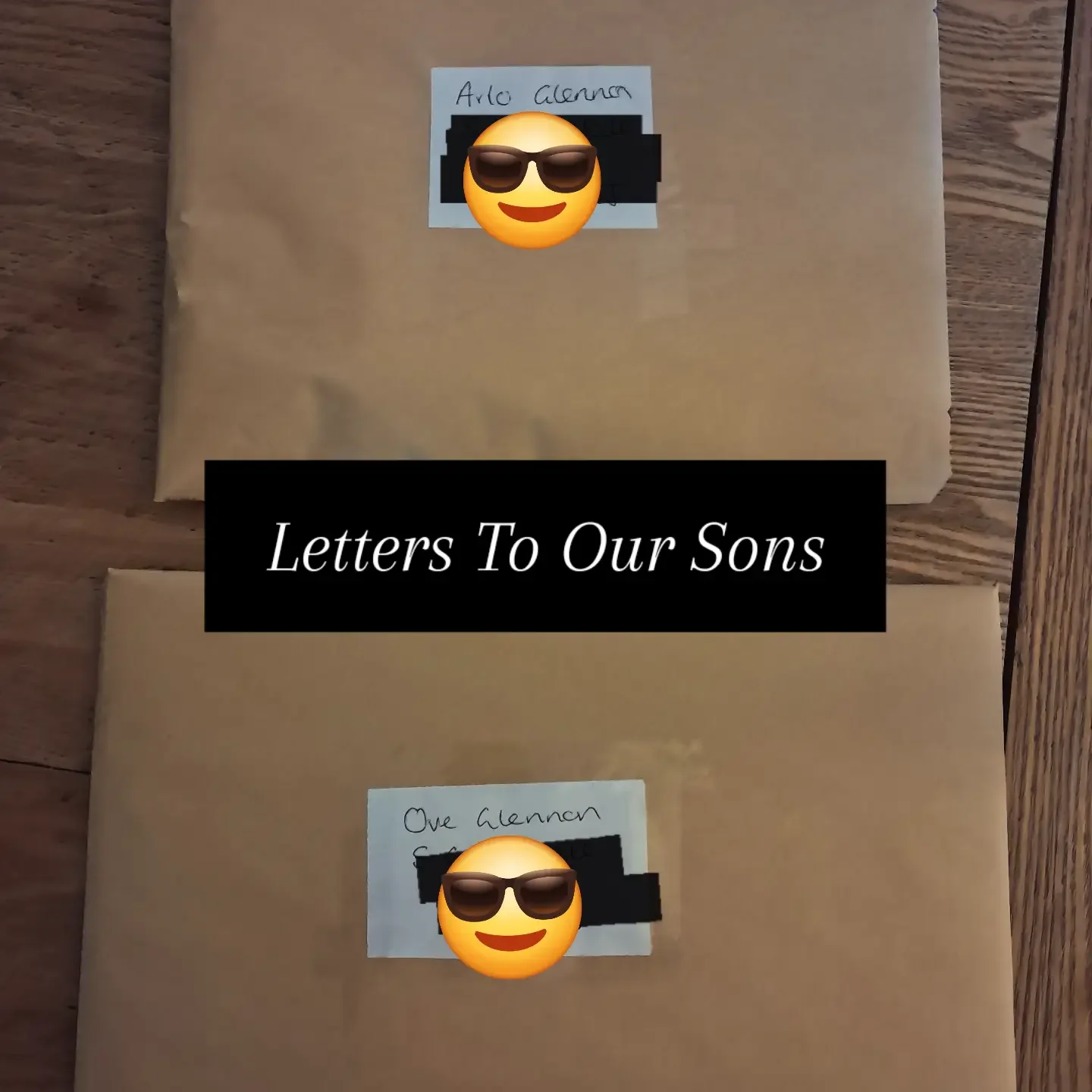 Two paper packages wrapped in brown paper with handwritten labels reading 'Alo Glean' and 'One Glean,' each with a smiley face emoji wearing sunglasses and a black bar obscuring part of the labels, with a black box caption stating 'Letters To Our Son