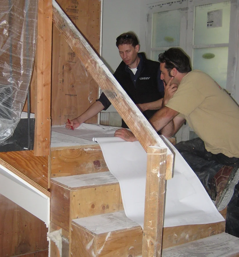 Architect Dan Rhoads discusses design changes with the contractor on site.