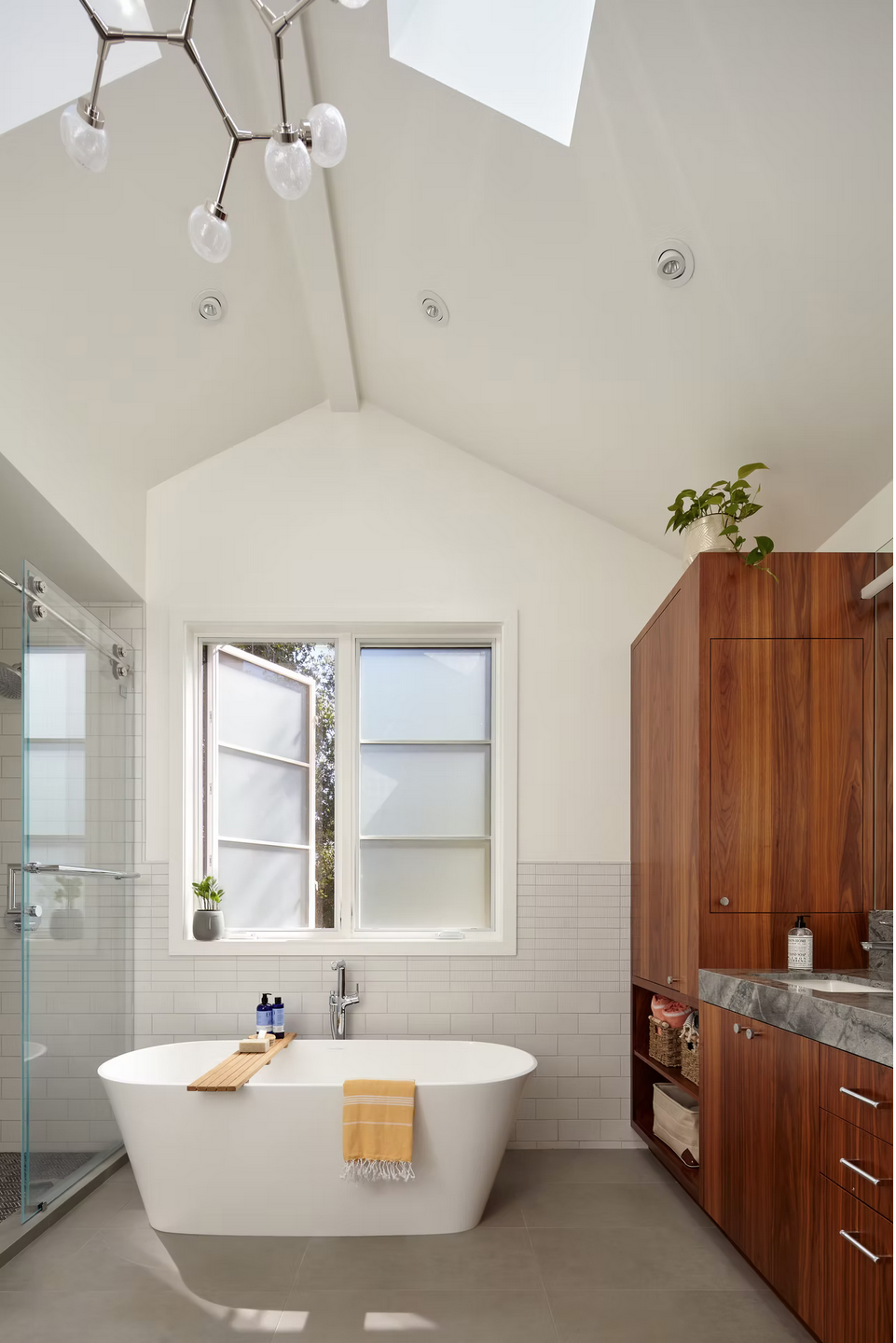 Modern bathroom with skylight and standalone tub