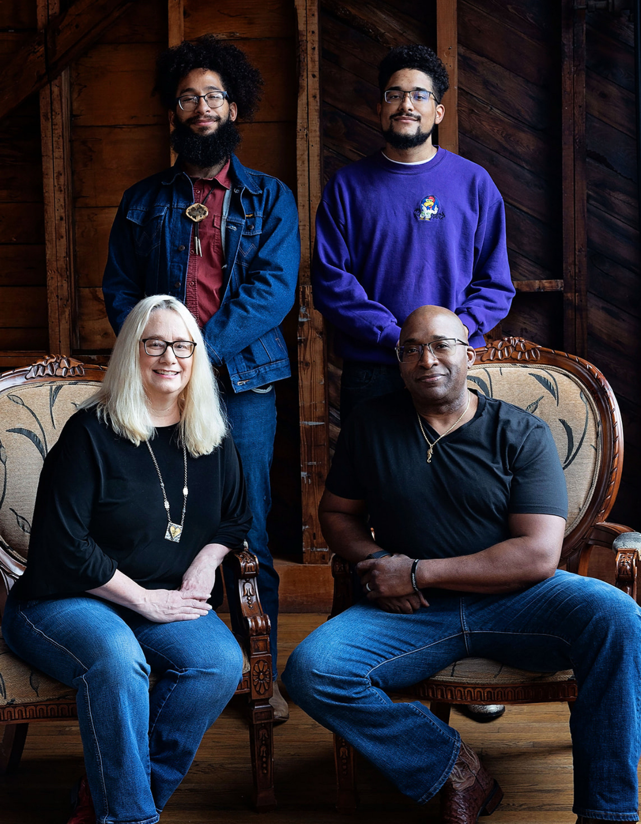 Dreama posing together indoors in front of a wooden wall, showcasing the people behind the organization and its mission.