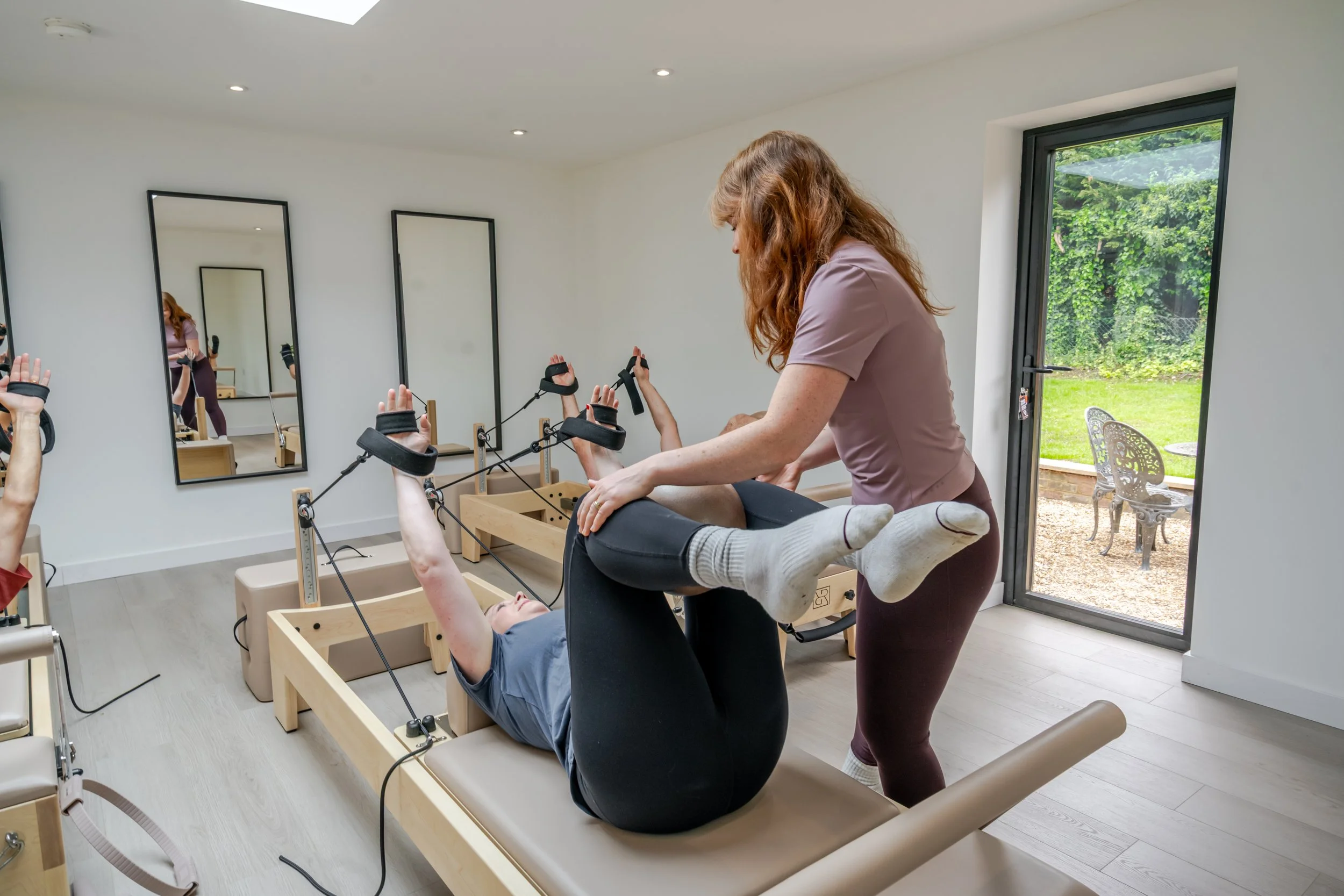Personalised reformer Pilates coaching in a calm boutique studio environment.