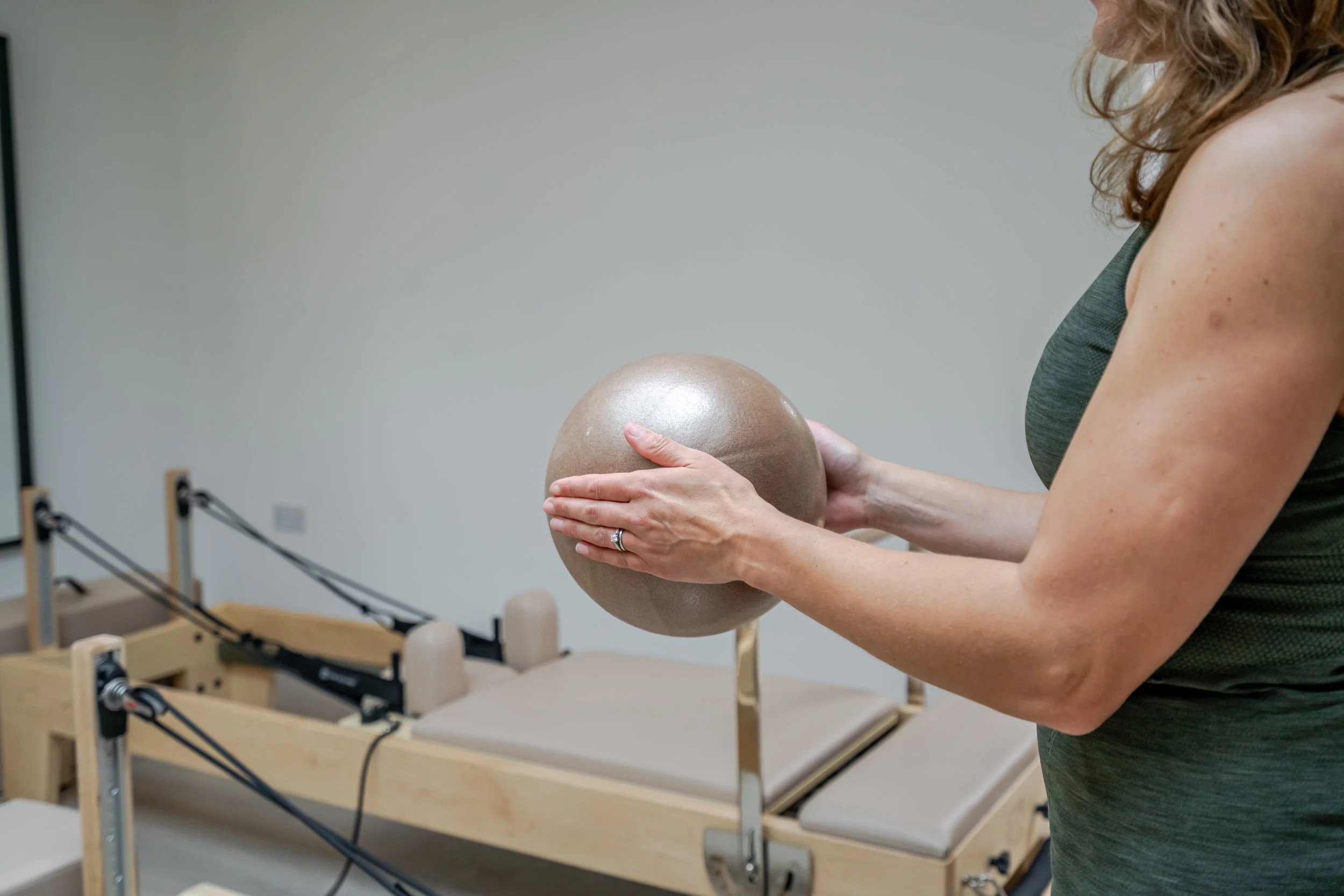 ball exercise during a private reformer Pilates session at Reform With Marina.