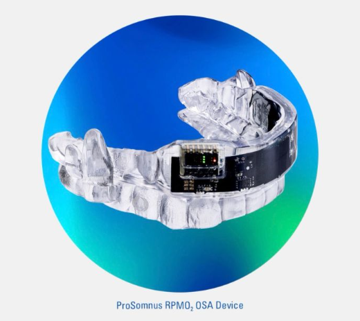 A clear dental aligner with an electronic device attached, set against a blue and green gradient background.