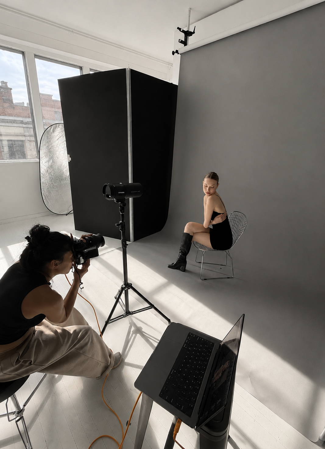 A photoshoot studio with large windows and different colored backdrop.