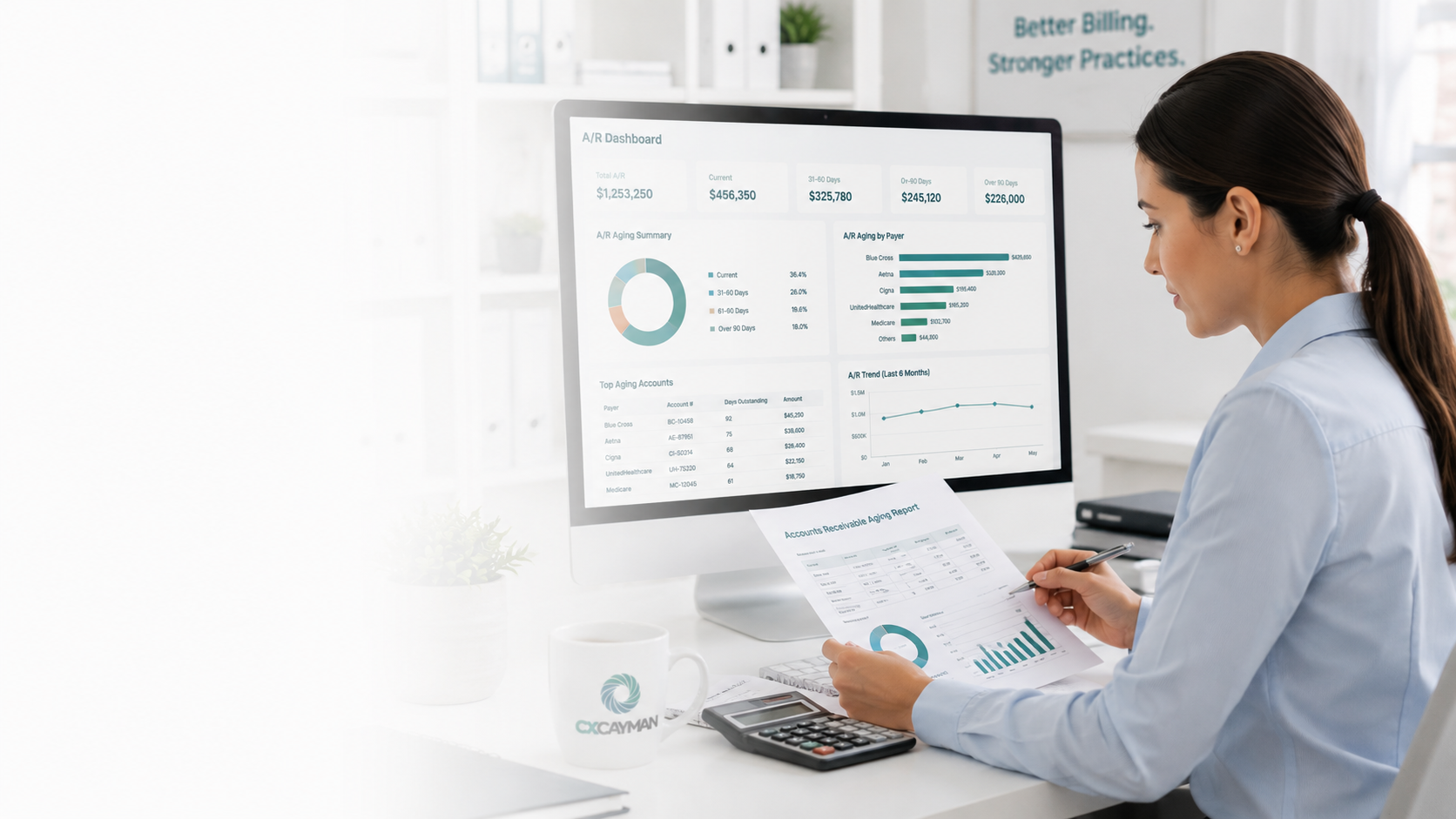 A woman working at her desk with a computer monitor displaying financial analytics, charts, and graphs, while she holds a document with similar data in her hands; there is a coffee mug, calculator, and a notepad on the desk.