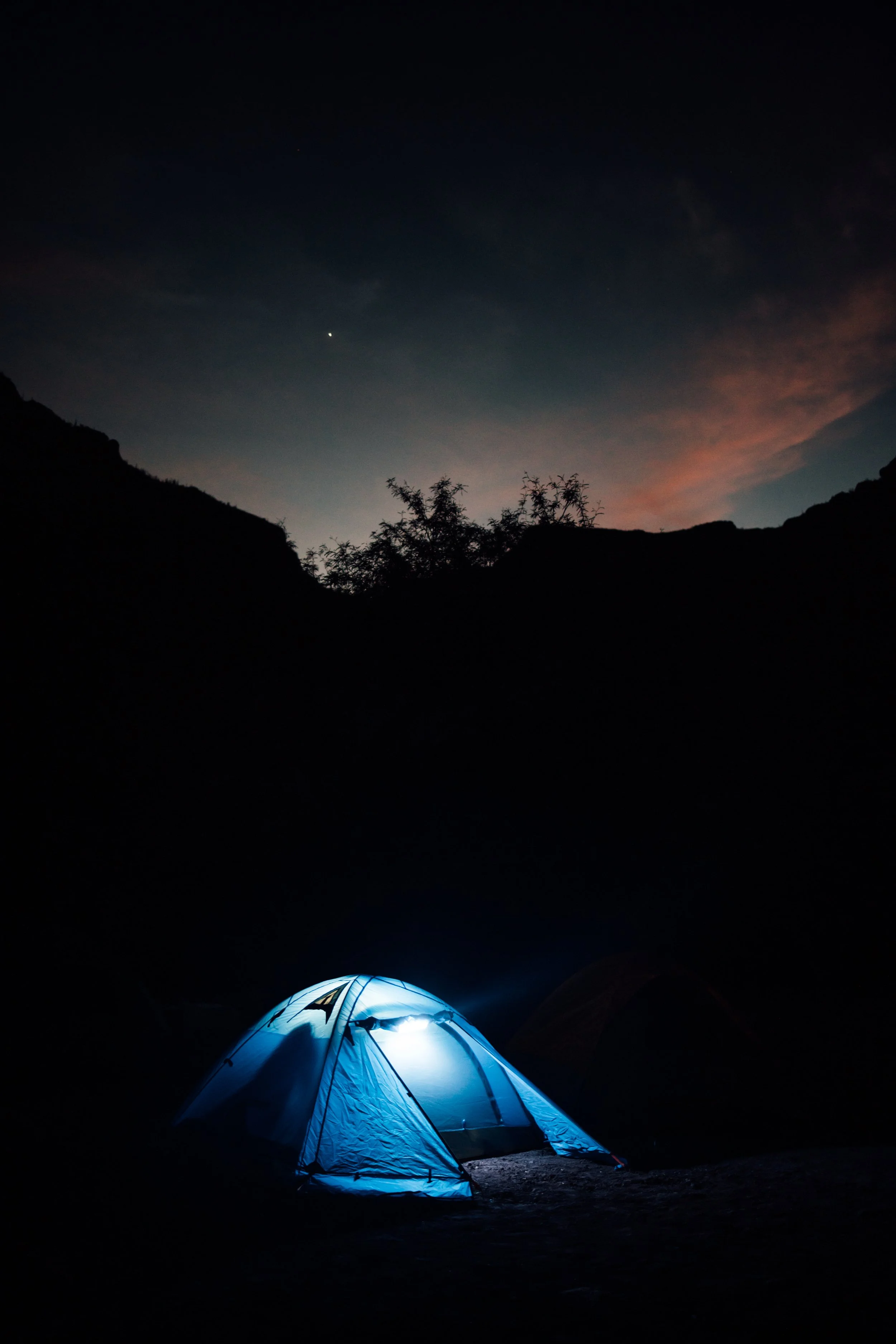 Casa de campaña iluminada durante la noche en la Sierra de San Francisco, Mulegé, Baja California Sur.