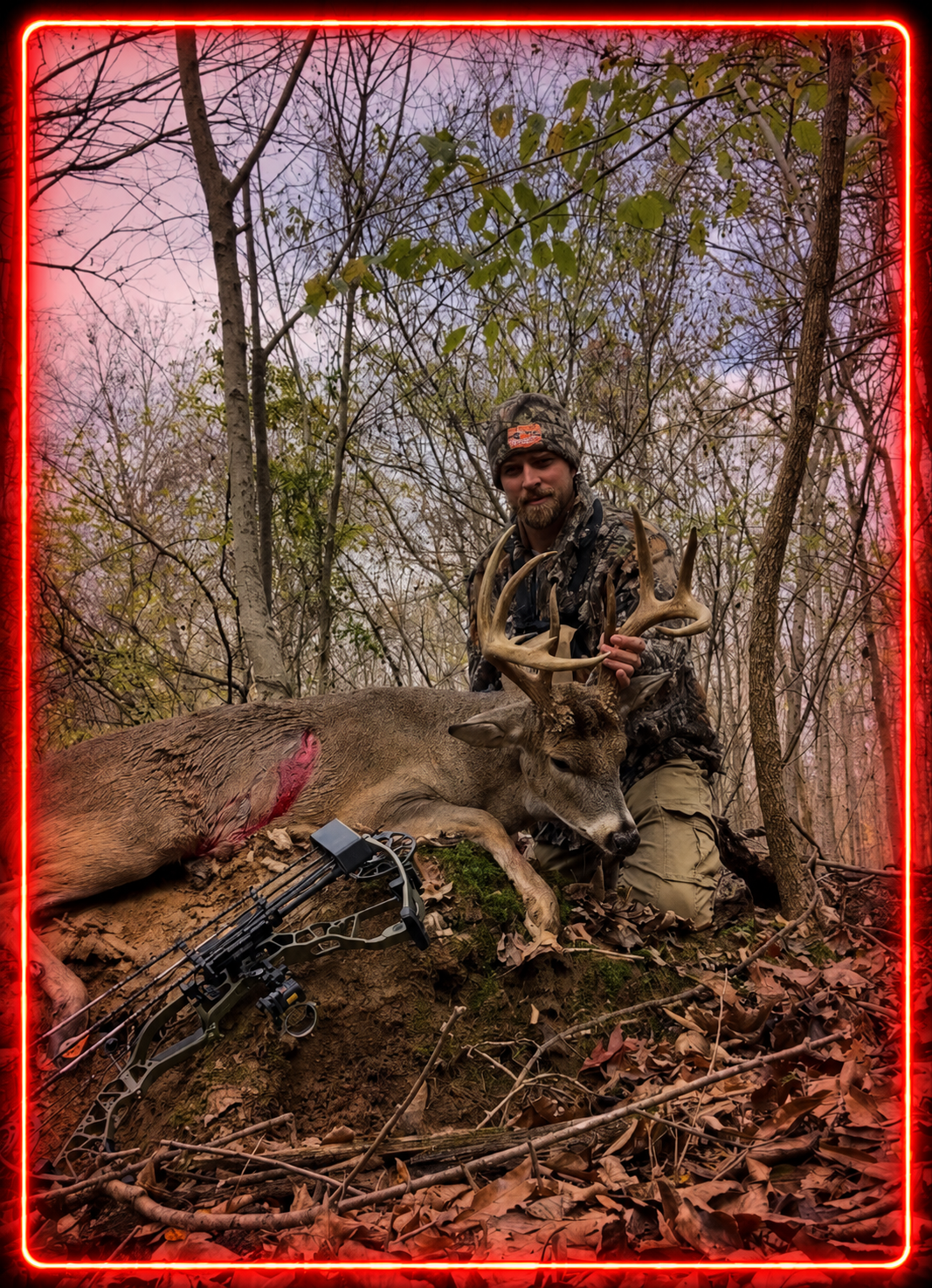 A hunter kneels in a wooded area behind a fallen deer with antlers, holding the deer's antlers, with a bow and arrow lying nearby. The scene is highlighted with a red neon border.