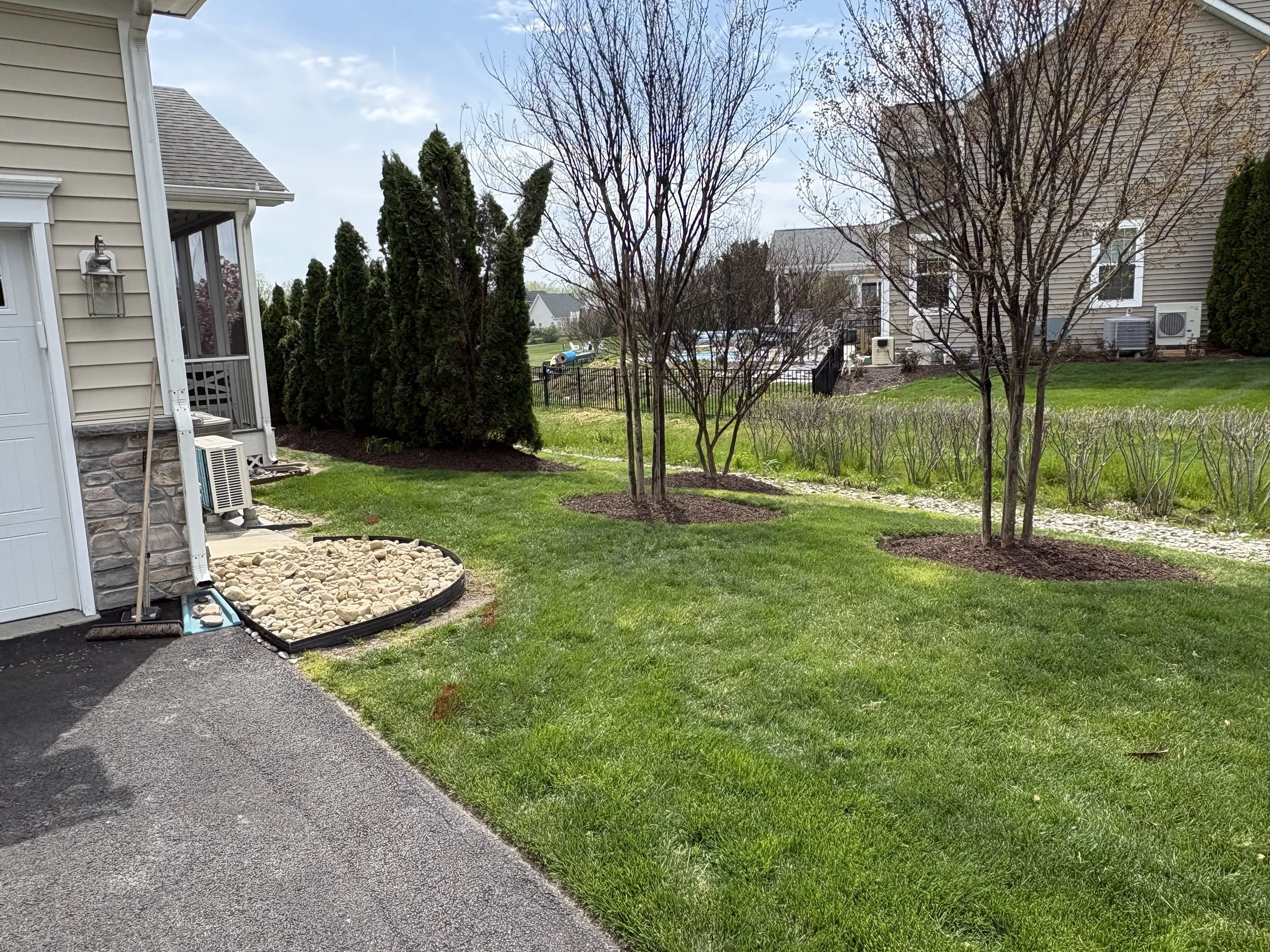 Freshly mulched shrub bed with clean edging after landscaping in Delaware