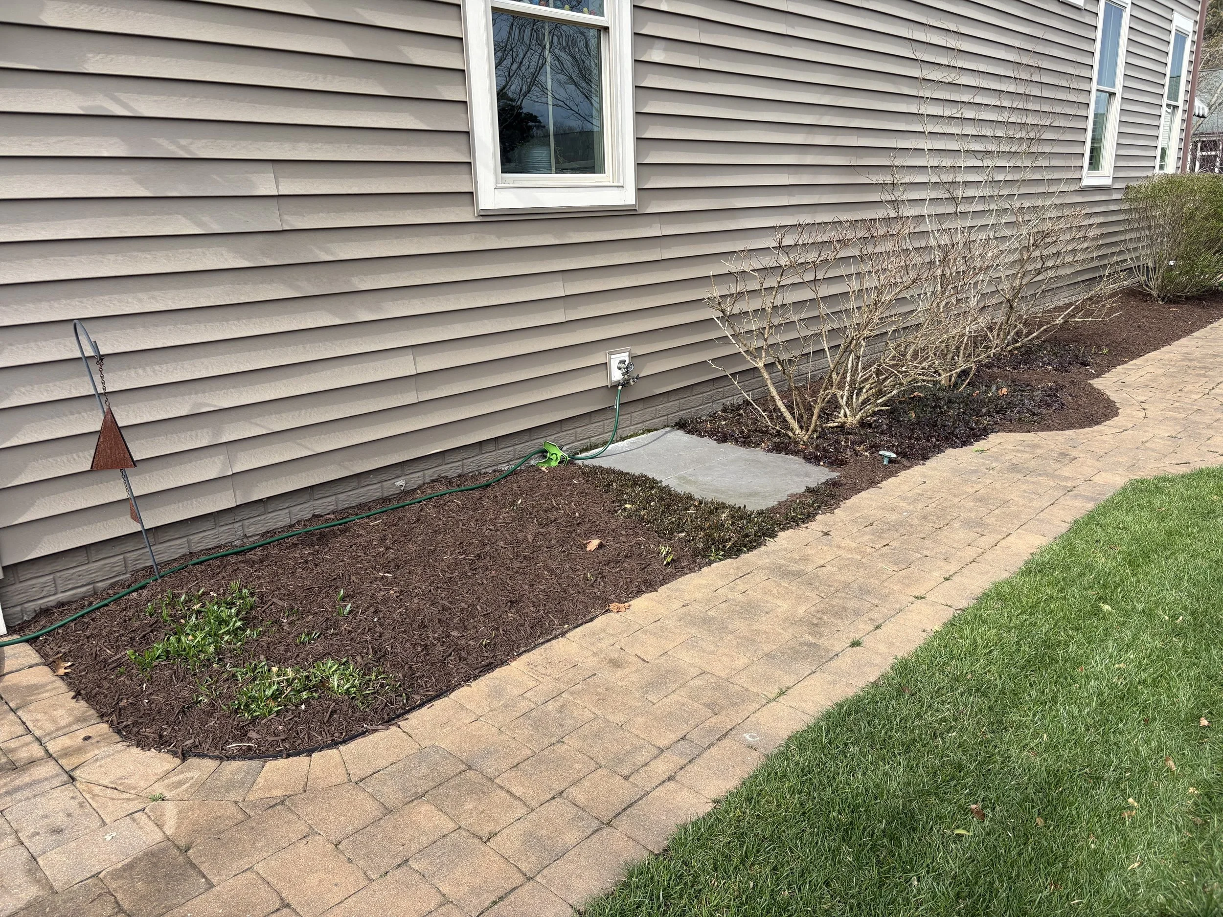 Stone border garden bed after landscaping refresh in southern Delaware