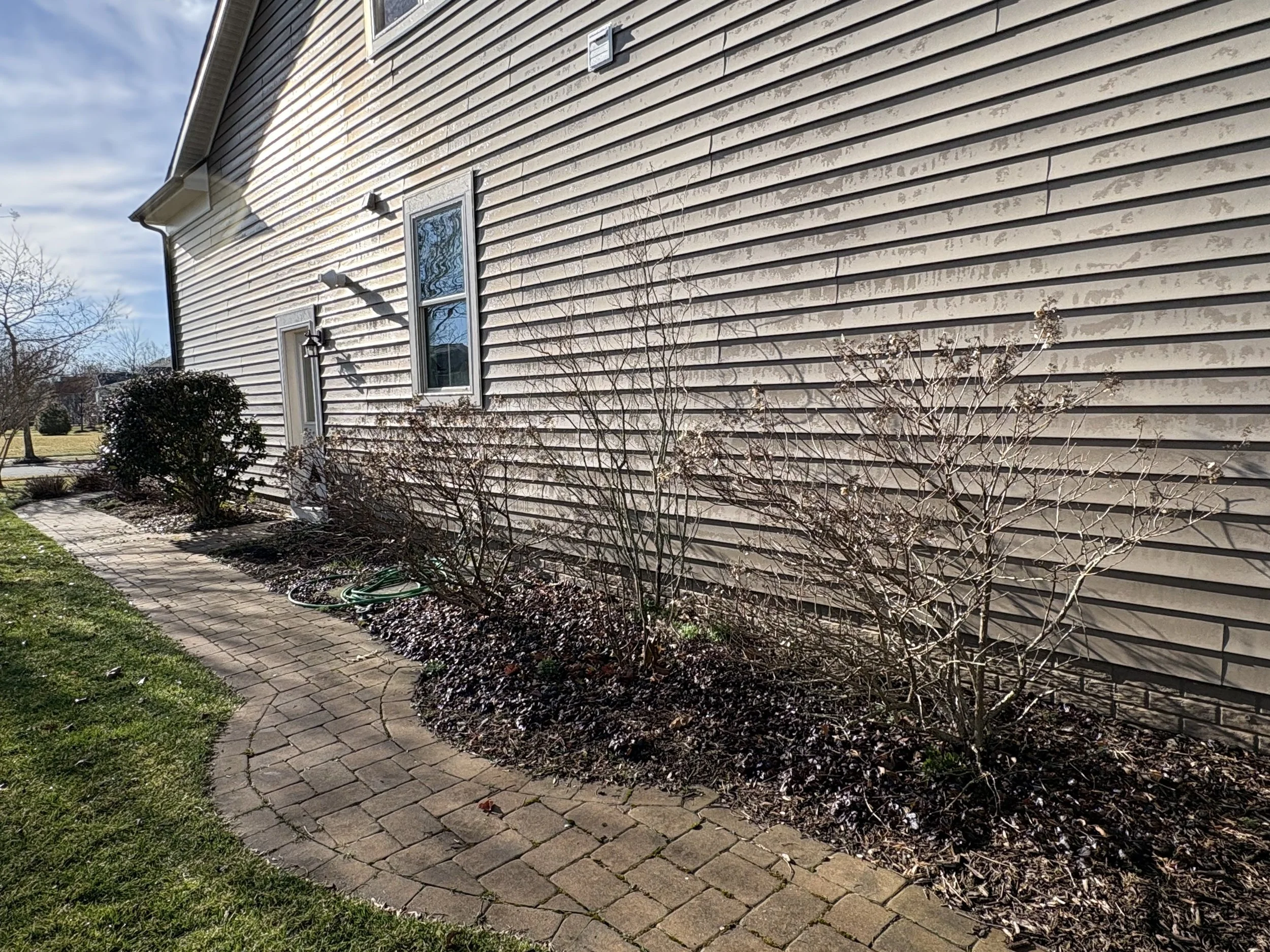 Stone border garden bed before landscaping refresh in southern