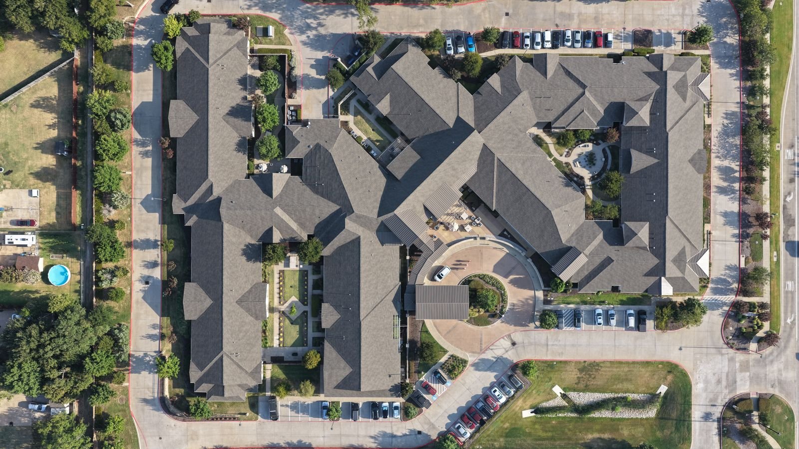 Aerial view of completed commercial roof replacement on a 75,000 sq ft senior living facility in Flower Mound, Texas