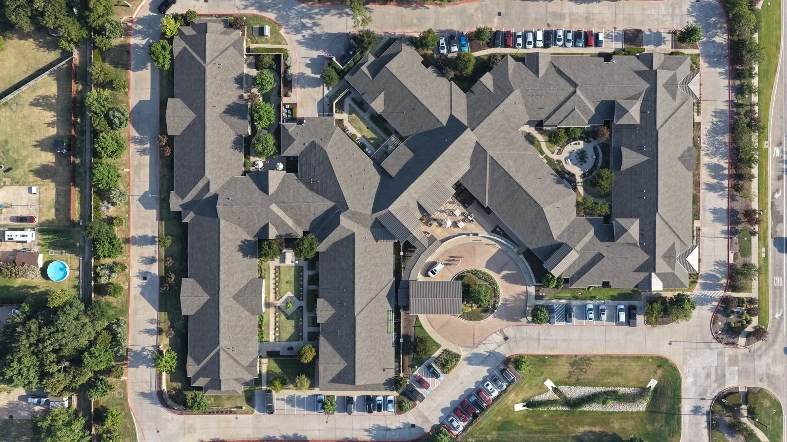 Aerial view of completed commercial roof replacement on a 75,000 sq ft senior living facility in Flower Mound, Texas