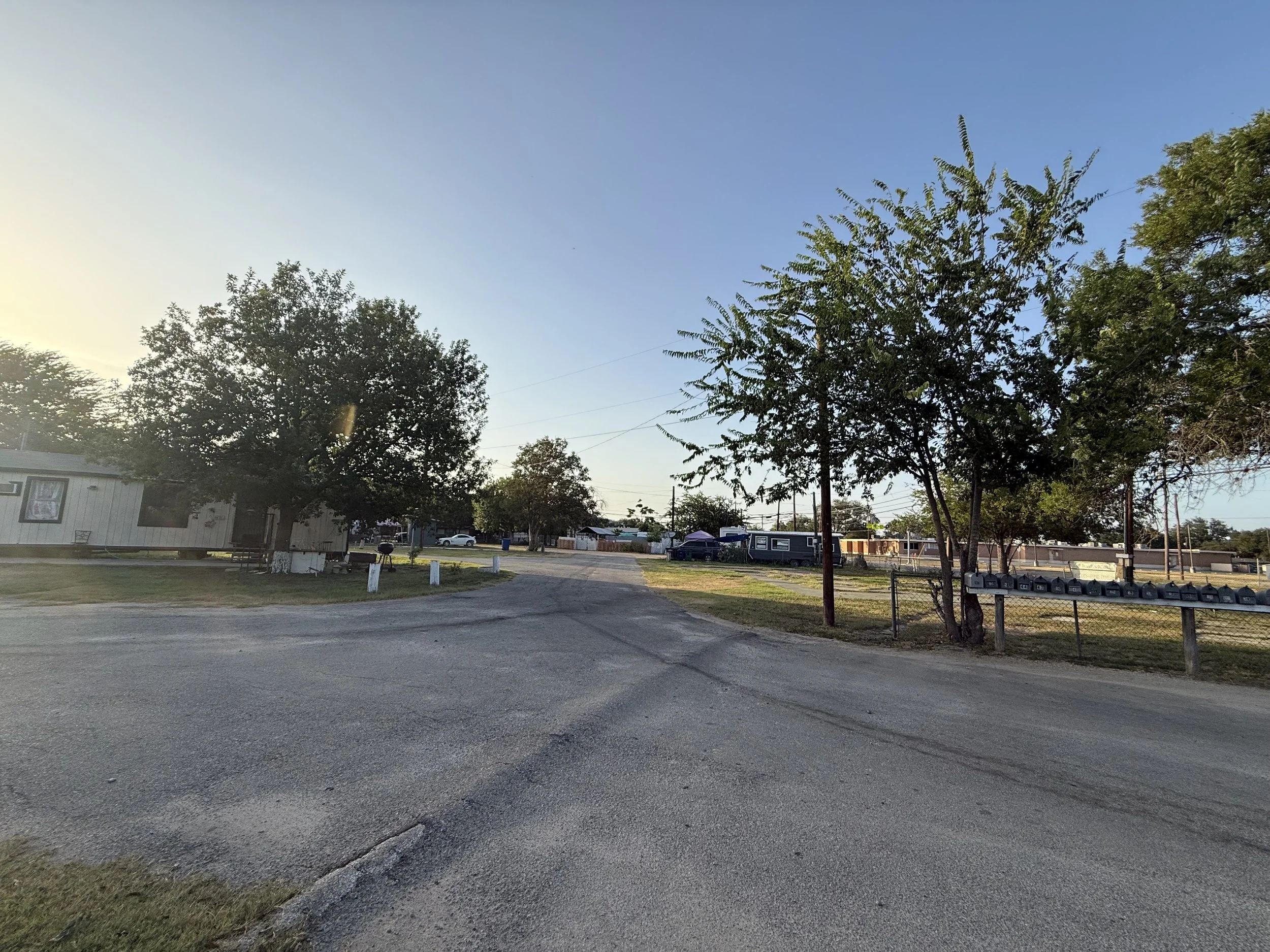 Flores Crossing long-term RV and mobile home community with mature trees and open interior roads