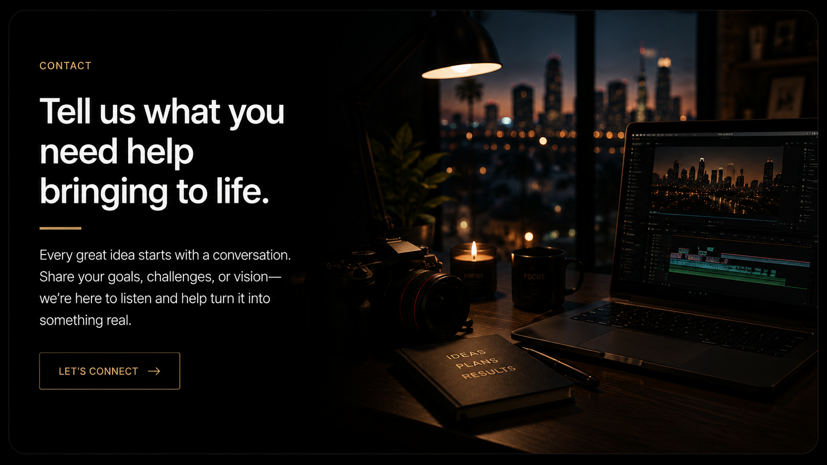 Dark office workspace with a computer showing a cityscape at sunset, a camera, notebooks labeled 'Ideas, Plans, Results,' a pen, two candles, and a candle with a light, overlooking a city skyline through the window.