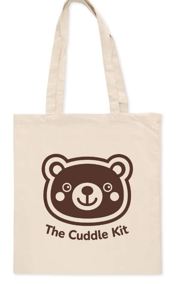 Cream Cuddle Kit canvas bag with a brown bear logo