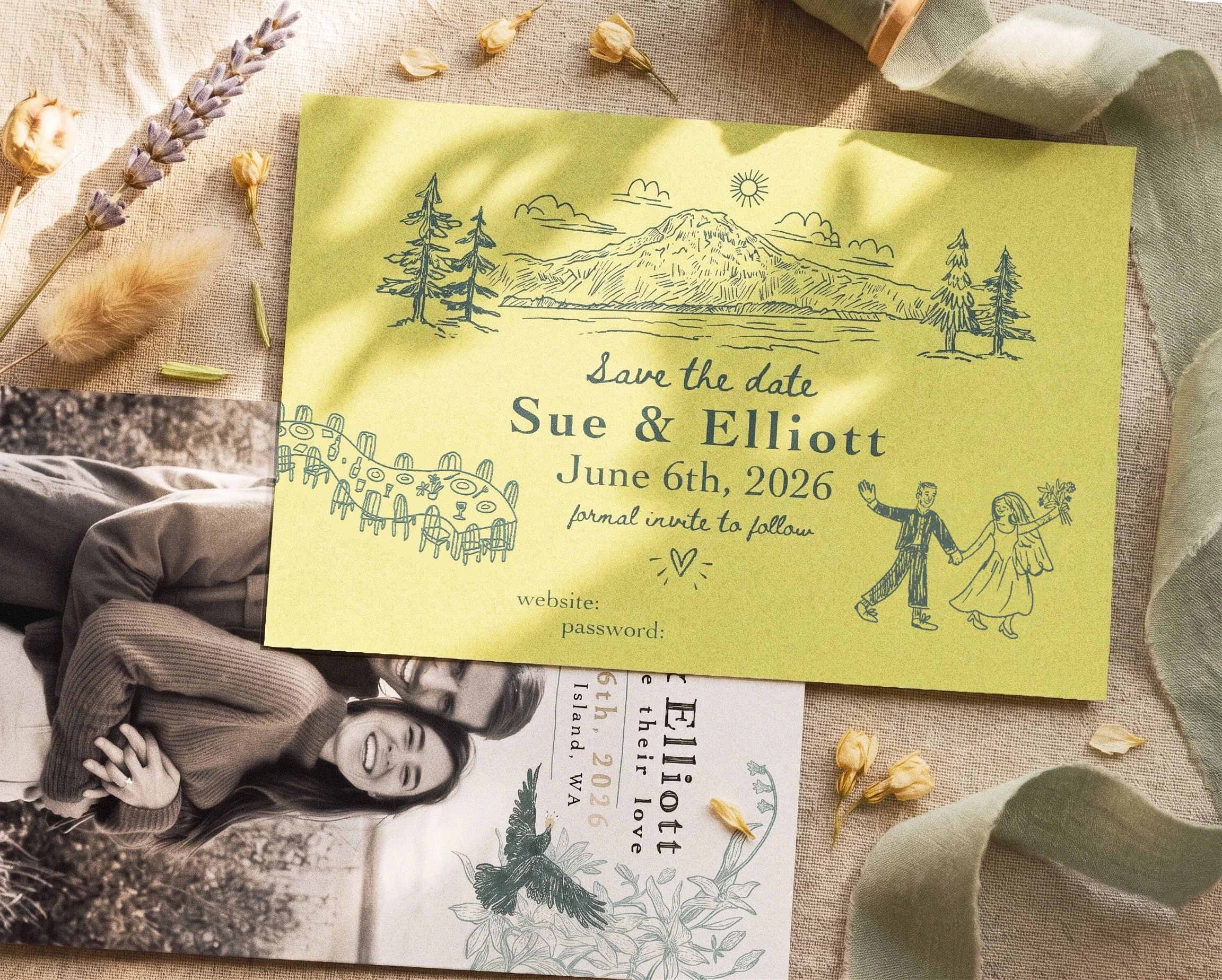A yellow wedding invitation with a mountain and trees drawing and couple illustrations, surrounded by dried flowers and fabric.