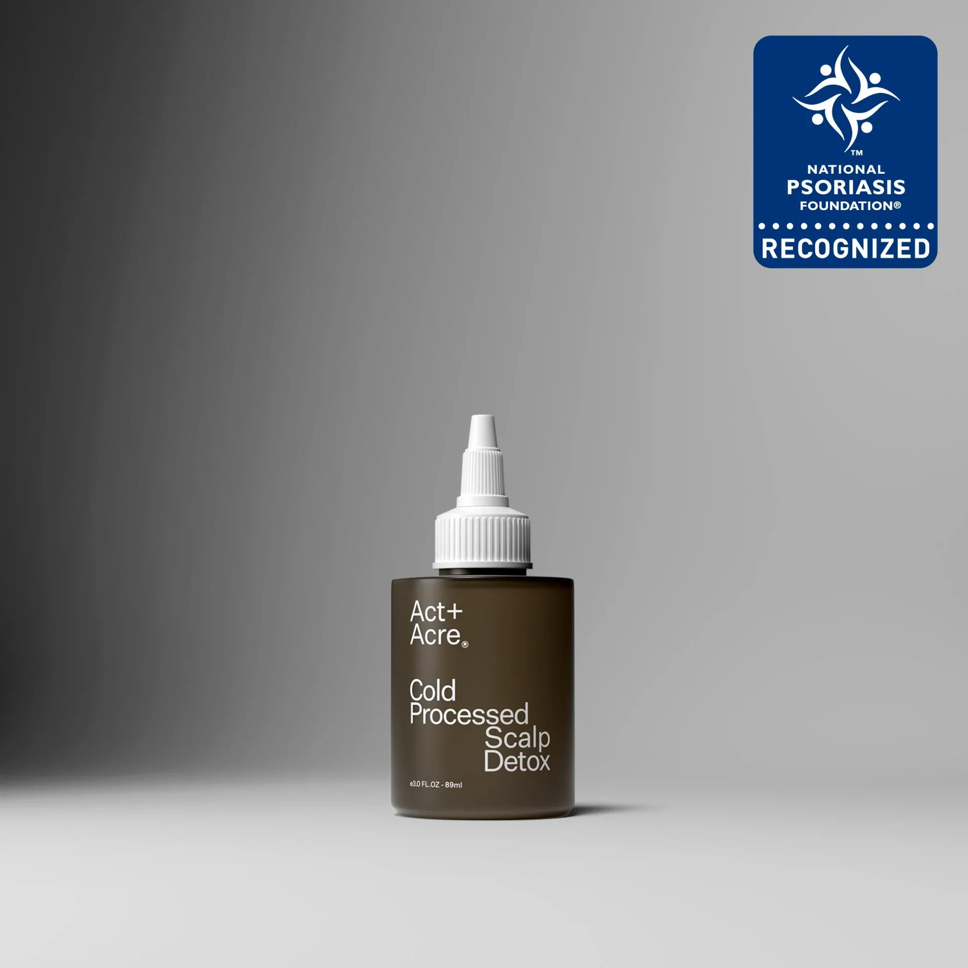 A bottle of scalp detox treatment with a spray nozzle on top, labeled Act+ Acre, Cold Processed.